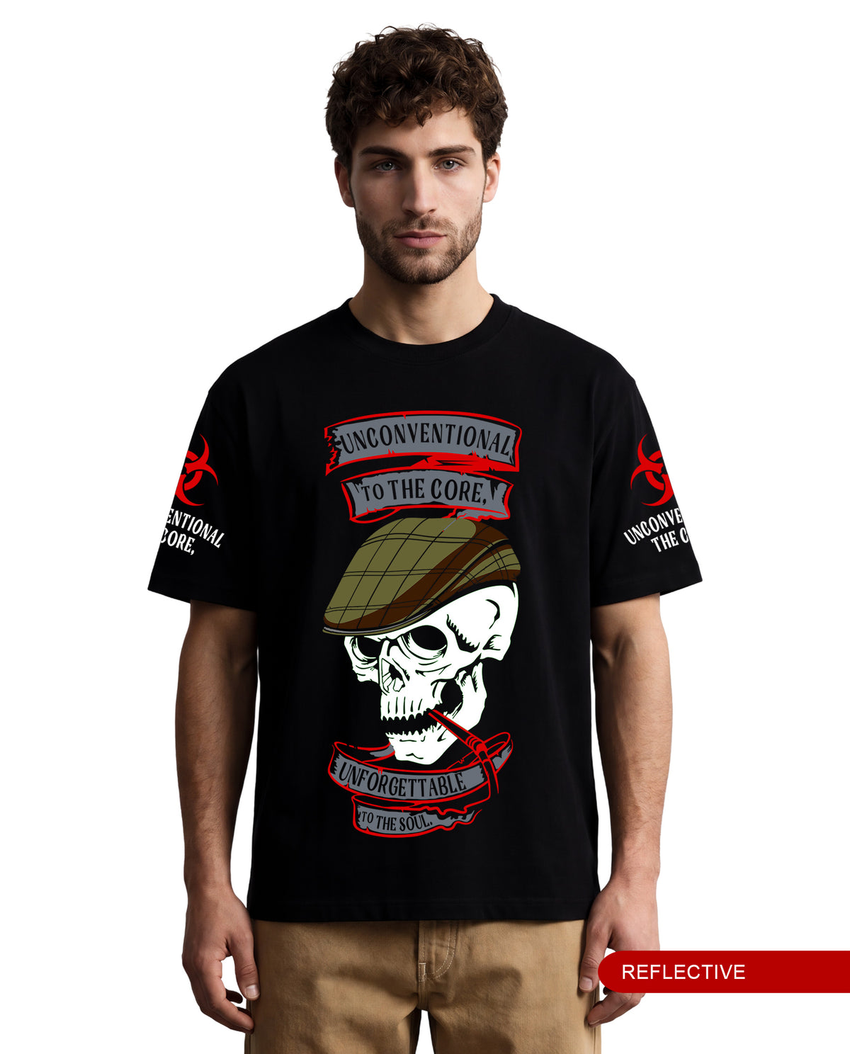 A man wearing a black short-sleeve graphic T-shirt with a large skull and red banner design on the front, plus red biohazard-style graphics on both sleeves. The shirt has reflective text and imagery including 'UNCONVENTIONAL TO THE CORE' and 'UNCONVENTIONAL IN THE CORE.