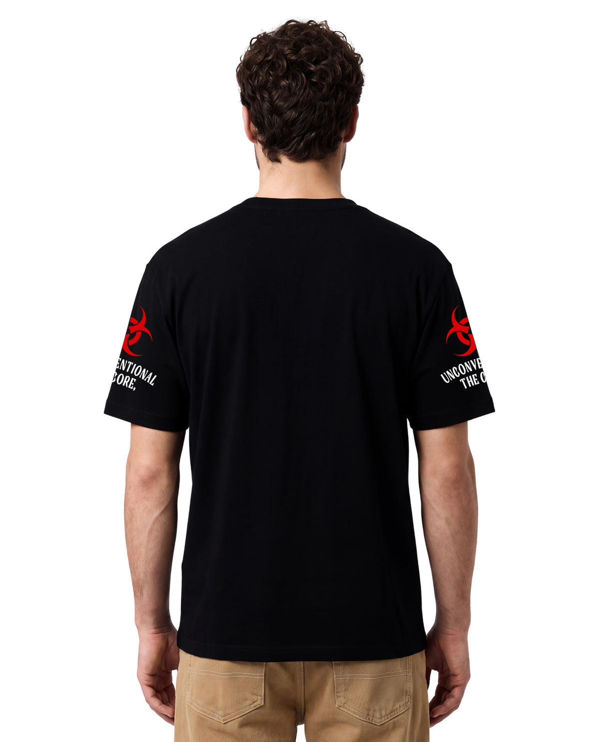 A man viewed from the back wearing a black short-sleeve t-shirt with red and white graphics on both sleeves, paired with khaki pants, against a plain white background.