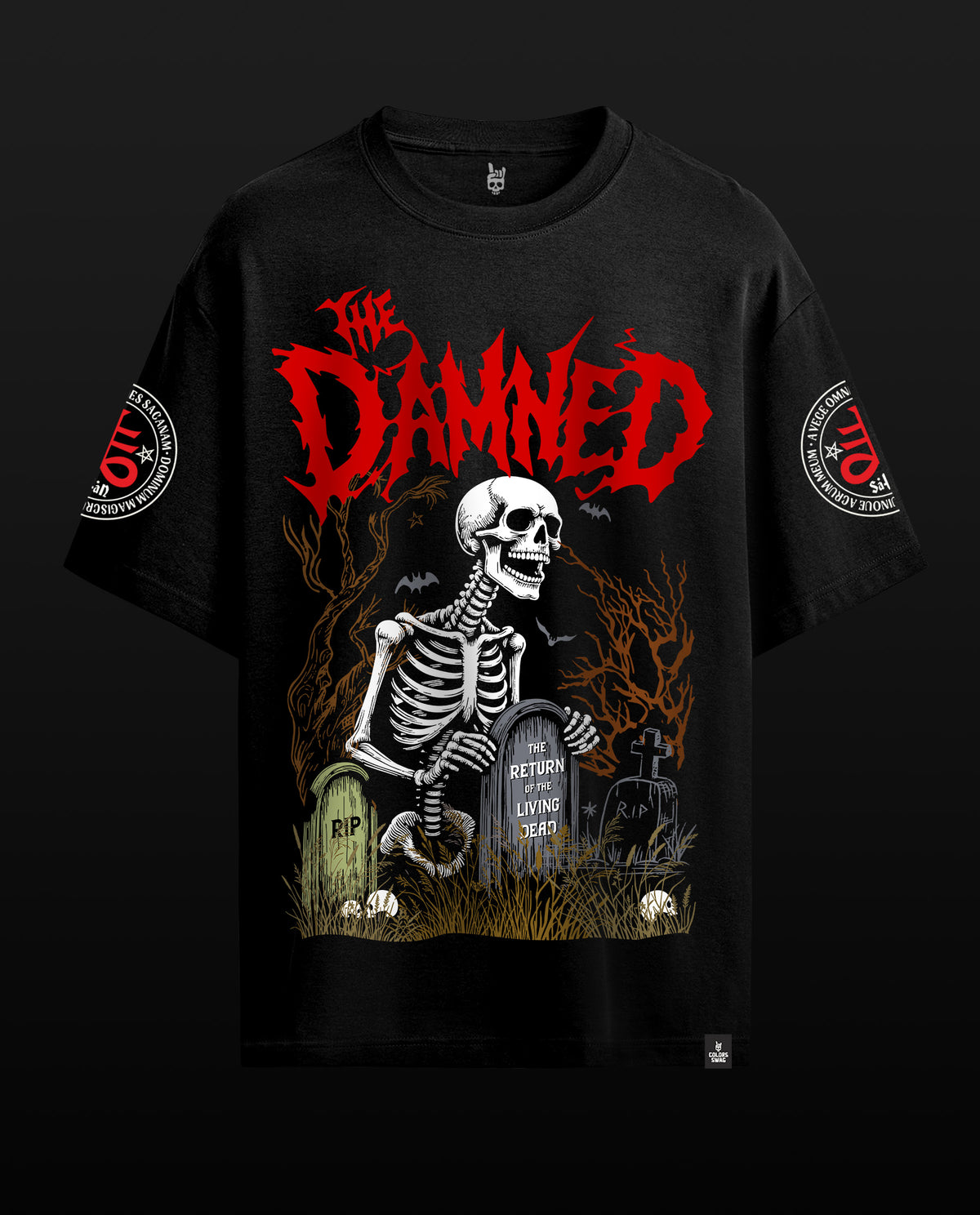 A black graphic t-shirt featuring a skeleton sitting at a graveyard with tombstones and the word 'The Damned' in large red font across the chest. The t-shirt is displayed against a solid black background.
